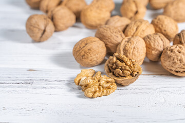 Walnuts kernels on white wooden desk, stock photo
