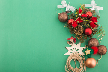 Christmas ornaments and decorations on green background.