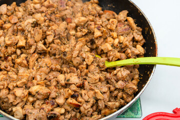 Fry almost ready-made meat for shawarma in a pan.