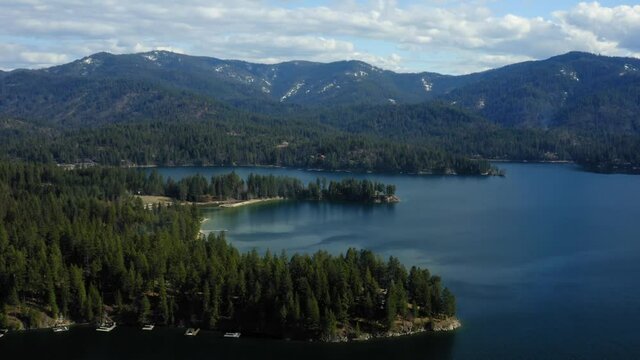 Scenic aerial drone view of mountains and beach over Hayden Lake Idaho