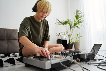 Woman wearing headphones push the button