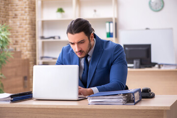 Young male businessman employee working in the office