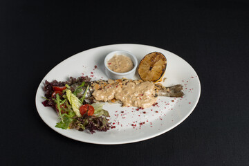 Stuffed trout with mushrooms sauce and salad