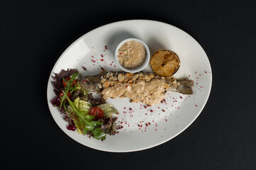 Stuffed trout with mushrooms sauce and salad