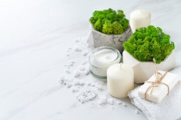 Beautiful spa composition with two pots of stabilized moss on a marble background. Copy space