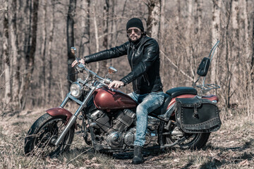 Fototapeta na wymiar Biker portrait. Photo with a motorcycle