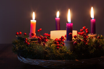 Advent wreath in dark room candles lit