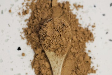 Guarana powder in wooden spoon on white marble background.Super food. Useful product. Healthy eating concept. Natural energetic. Portion of Guarana Powder.