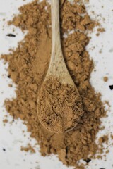 Guarana powder in wooden spoon on white marble background.Super food. Useful product. Healthy eating. Natural energetic. Portion of Guarana Powder.