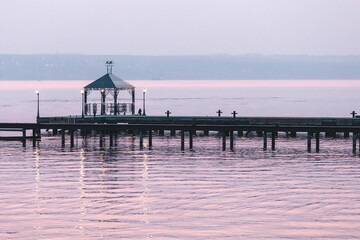 Large metal pier in the water in the sunset. High quality photo