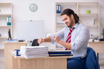 Young male employee unhappy with excessive work