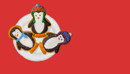 Gingerbread cookie of cute penguin on background. Traditional Christmas food. Christmas and New Year holiday concept..Hand painted. Comfort food. Christmas treat. Tradition.