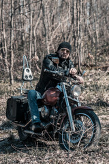 Naklejka na ściany i meble Biker portrait. Photo with a motorcycle