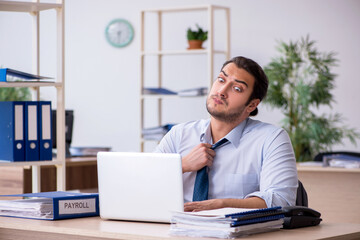 Fototapeta premium Young male bookkeeper working in the office