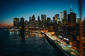 Manhattan skyscrapers and bridge in evening