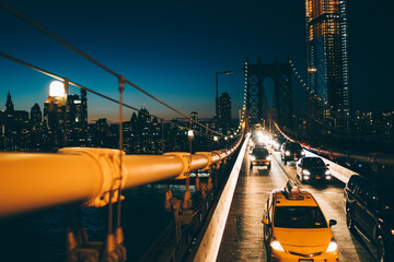 Cars driving on Manhattan bridge in New York at night