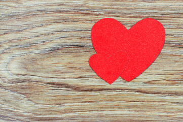 Red hearts on a wooden background. Paper hearts.