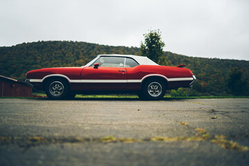 Fototapeta na wymiar Red vintage American car on street