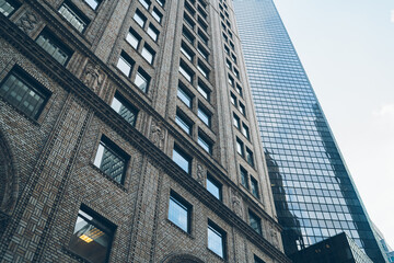 Obraz premium Tall old and new buildings in New York City