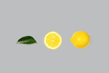 Creative layout made of bright illuminating yellow lemons on gray color background.
