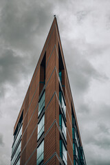 A large tall tower with a cloudy sky