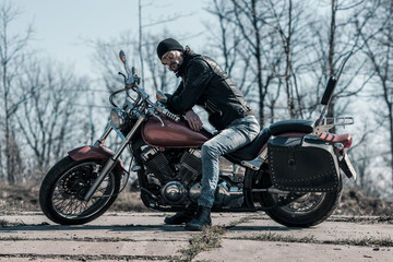 Obraz na płótnie Canvas Biker portrait. Photo with a motorcycle
