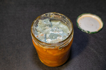 A jar of spoiled cooking with mold.