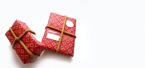 Christmas red gift box in on white background. Space for text. The concept of the delivery of gifts and greetings card happy New year. Holiday banner, flyer, greeting card.