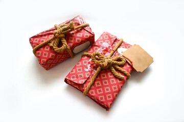 Christmas red gift box in on white background. Space for text. The concept of the delivery of gifts and greetings card happy New year. Holiday banner, flyer, greeting card.