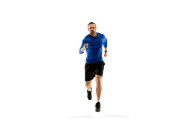 Ready. Caucasian professional jogger, runner training isolated on white studio background. Muscular, sportive man, emotional. Concept of action, motion, youth, healthy lifestyle. Copyspace for ad.