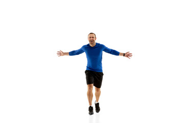 Fototapeta na wymiar Expression. Caucasian professional jogger, runner training isolated on white studio background. Muscular, sportive man, emotional. Concept of action, motion, youth, healthy lifestyle. Copyspace for ad