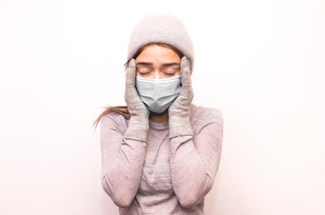 Young girl in mask and gray clothes isolated on white background
