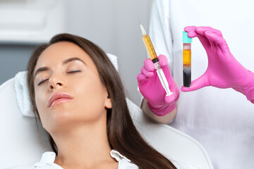 Beautician will do PRP therapy for the face against wrinkles. She has blood plasma for injections...