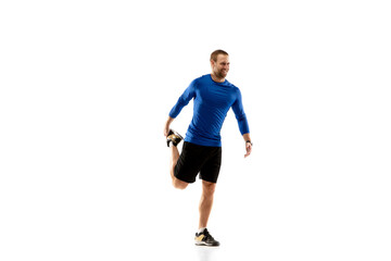 Naklejka na ściany i meble Prepares. Caucasian professional jogger, runner training isolated on white studio background. Muscular, sportive man, emotional. Concept of action, motion, youth, healthy lifestyle. Copyspace for ad.