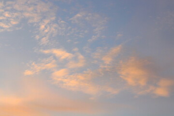 Pink clouds illuminated by the sun at dawn or sunset. Evening or morning dramatic sky
