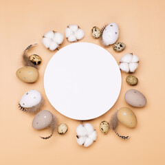 Fototapeta na wymiar Easter eggs on beige pastel background with space for text. Flat lay image composition, top view.