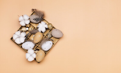 Easter eggs on beige pastel background with space for text. Flat lay image composition, top view.