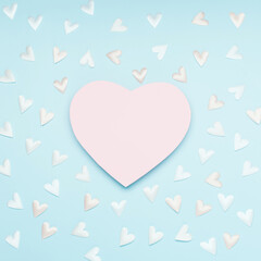 Pink white textile hearts on pastel blue background. Valentines day concept. Flat lay, top view, copy space.