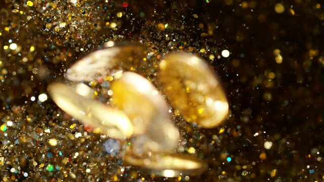 Cryptocurrencies Bitcoins flying with gold shiny glitters. 4k, 1000 fps. 4k, 1000 fps, super slow motion.