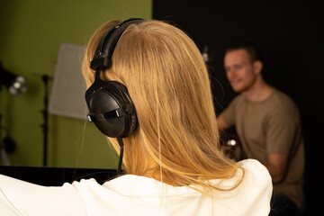 Caucasian woman sound composer in recording studio with vocalist singer 