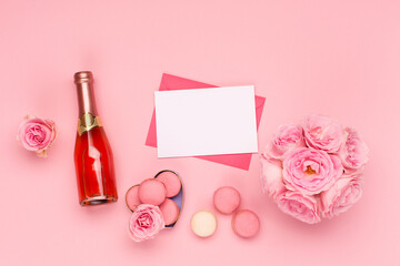 Obraz na płótnie Canvas Flowers roses, envelope and sweets macaroons on pink background. Valentines day concept. Flat lay, top view, copy space.