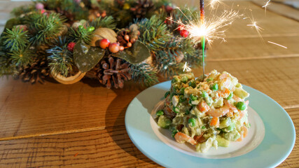 Christmas vein and holiday salad Olivier with burning sparklers. Christmas and celebrate concept.