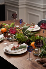 Christmas table setting with white plates and Christmas tree