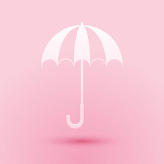 Paper cut Classic elegant opened umbrella icon isolated on pink background. Rain protection symbol. Paper art style. Vector.