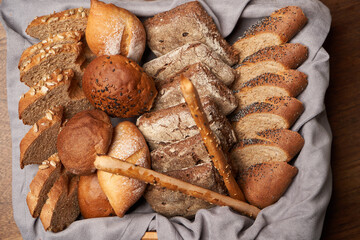 Basket with fresh bread on wooden table background