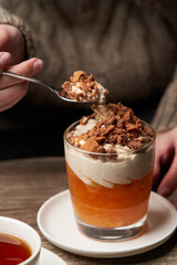Woman eating Persimmon pudding. Woman having breakfast