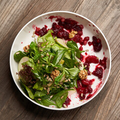 Spinach salad in a white bowl. Healthy diet salad