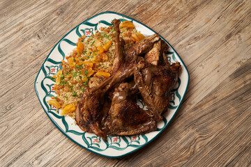 Roasted turkey and couscous on wooden table background