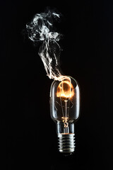 A broken incandescent light bulb is lit
