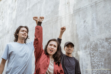 Portrait students who are burning with enthusiasm doing a demonstration together